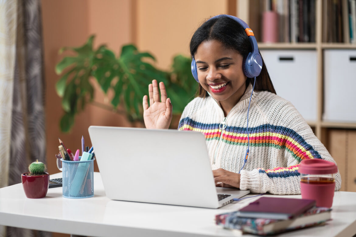 Young African American Girl Doing online video call with teacher from home