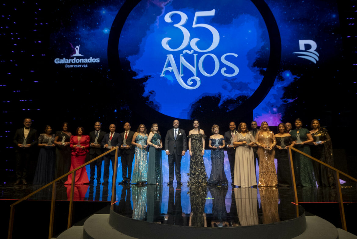 Samuel Pereyra, administrador general de Banreservas, y Fraysis Moronta, directora general senior de Capital Humano, entregan el reconocimiento a los colaboradores que cumplieron 35 años de servicio en la entidad financiera.